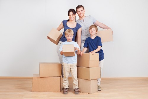 Professional movers carrying furniture during a same day relocation