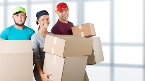 Moving team handling house removals in Richmonduponthames on a residential street