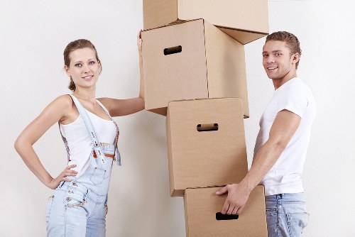 Removal crew carrying household items through a residential property